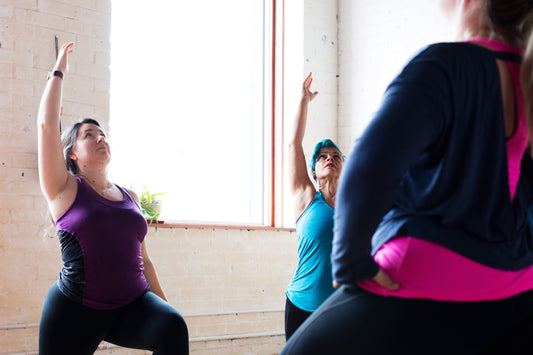 Beginners practicing yoga together, focusing on breath and movement rather than perfect poses.